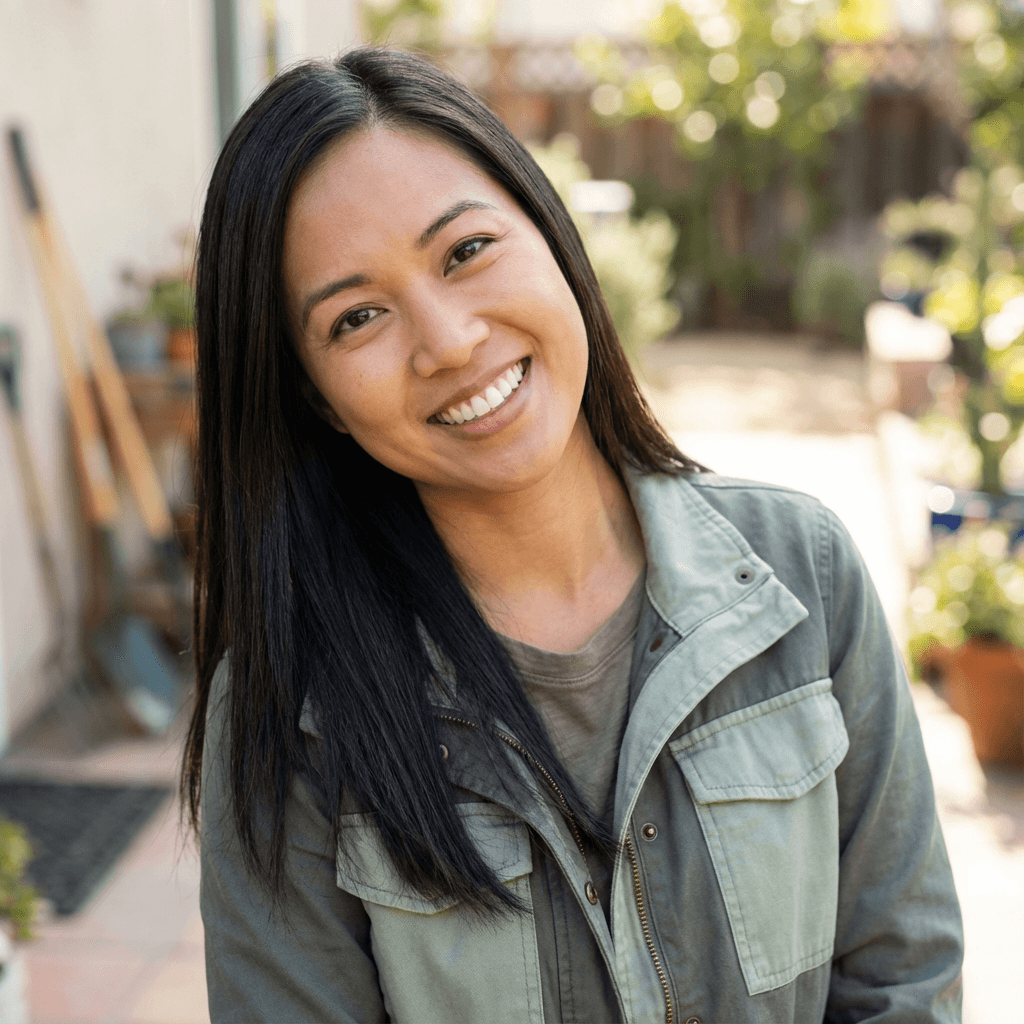 Sarah T. with a calm and composed look in a warm setting